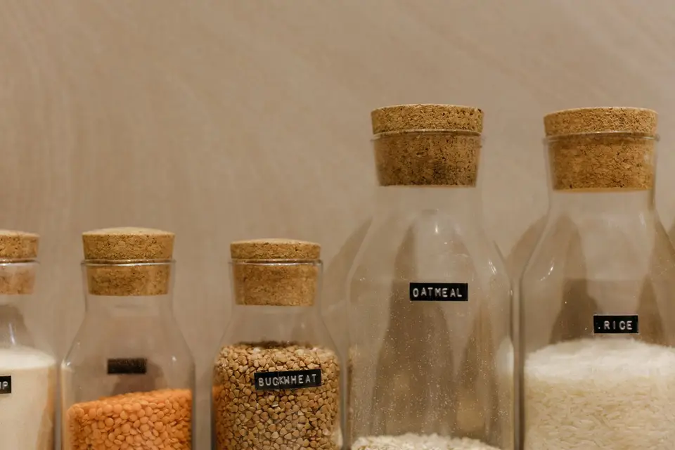 Pantry shelf with packaged foods, each showing a printed date on the label.